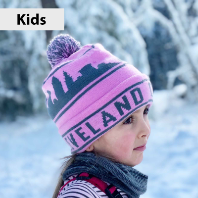 Child wearing a pink knit hat with 'Cleveland' text in a snowy landscape